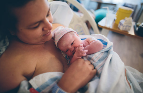 Albany NY birth photography mom holding baby in hospital