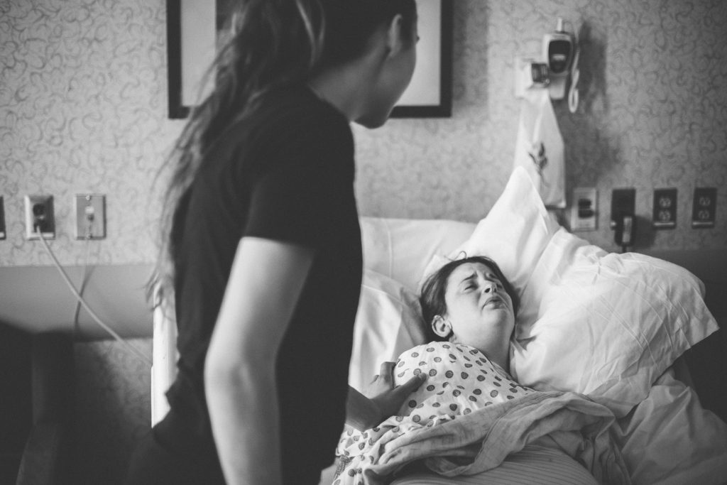 doula soothing woman during labor Albany NY birth photography
