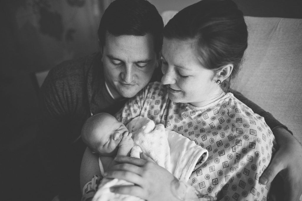 fresh 48 photographer in Albany New York mom and dad holding baby in hospital