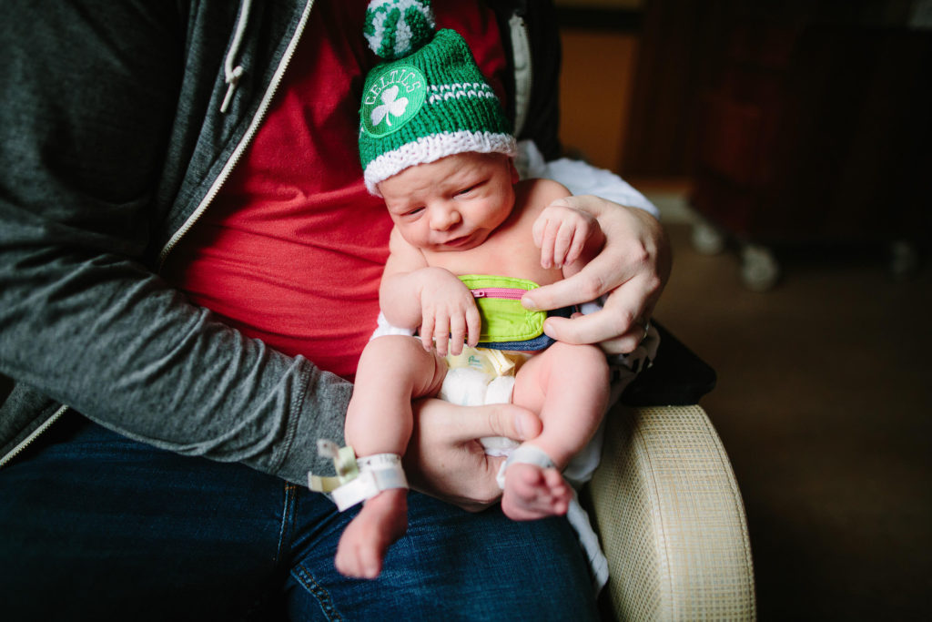 newborn baby in green hat at hospital for fresh 48 session Albany NY