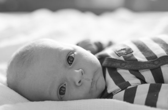 Close up newborn baby boy in striped shirt