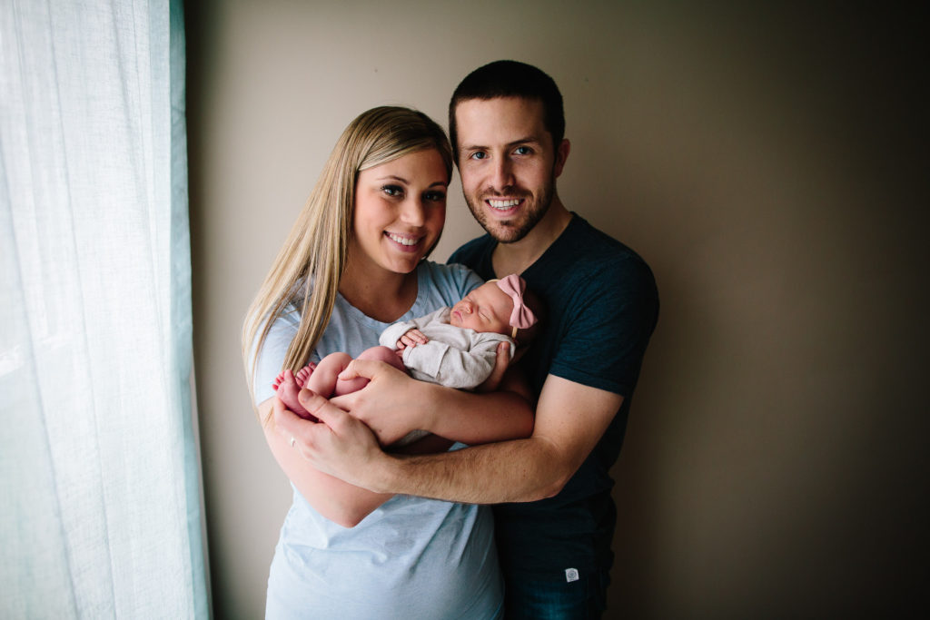 mom and dad holding baby Lifestyle newborn photography Albany NY