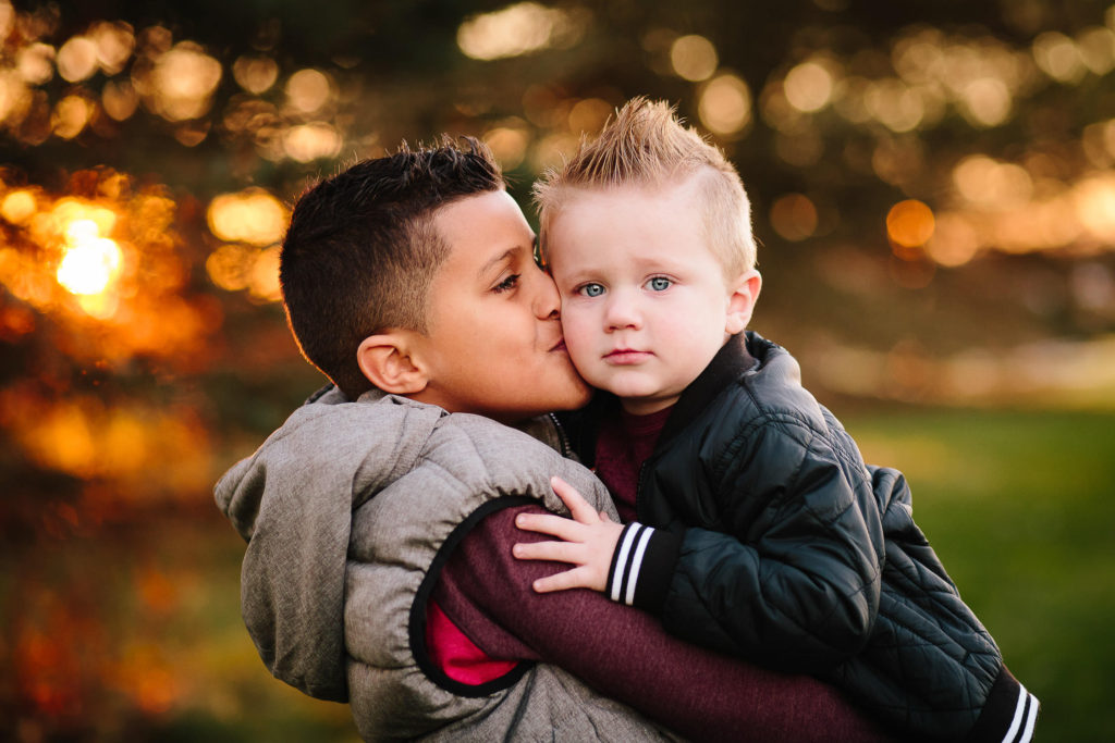 Older brother kissing baby brother Clifton park new York family Photographer