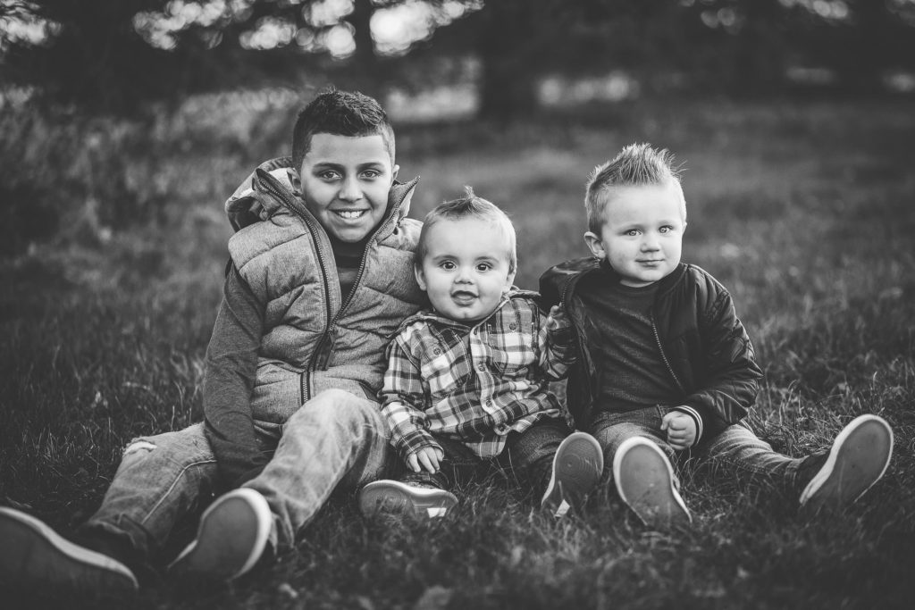 Three boys sitting in Halfmoon Town Park NY Capital Region Family photographer