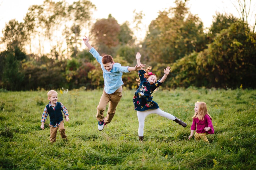 kids jumping in field at Garnsey Park in Clifton Park New York