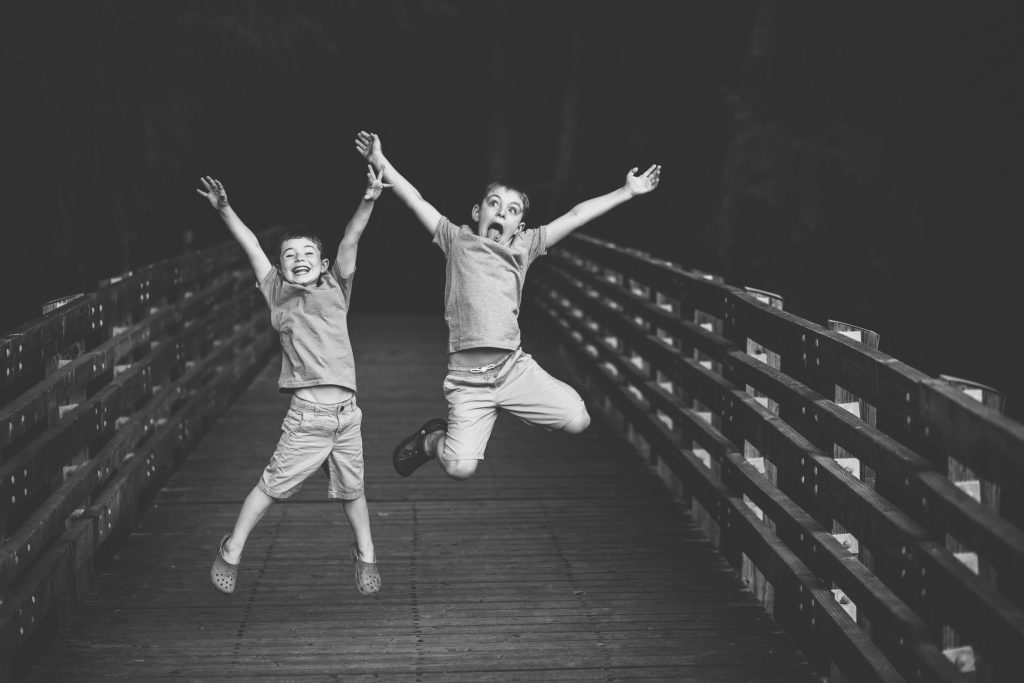 Clifton park Family Photographer two boys jumping in the air