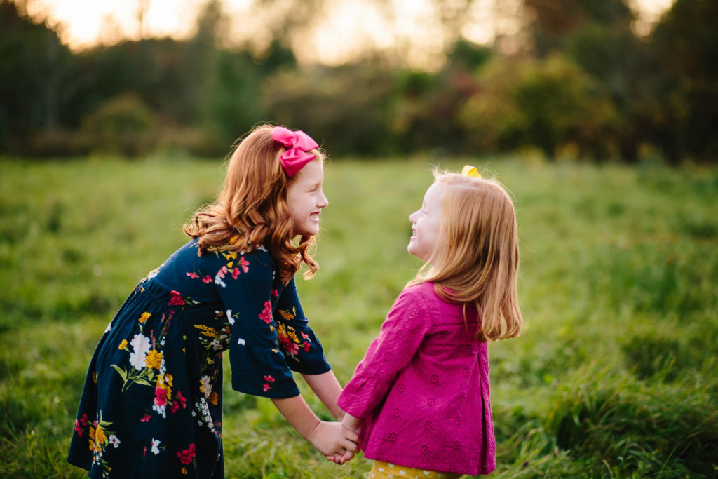 Sisters looking at each other at garnsey park in Clifton park New York