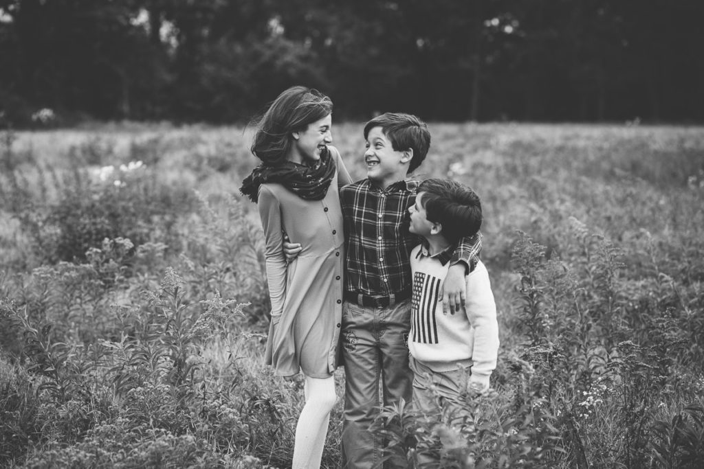 sibling standing in a field Clifton park NY Family Photography