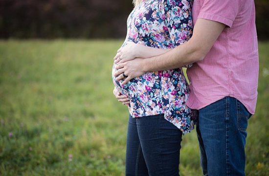 Maternity hands holding belly