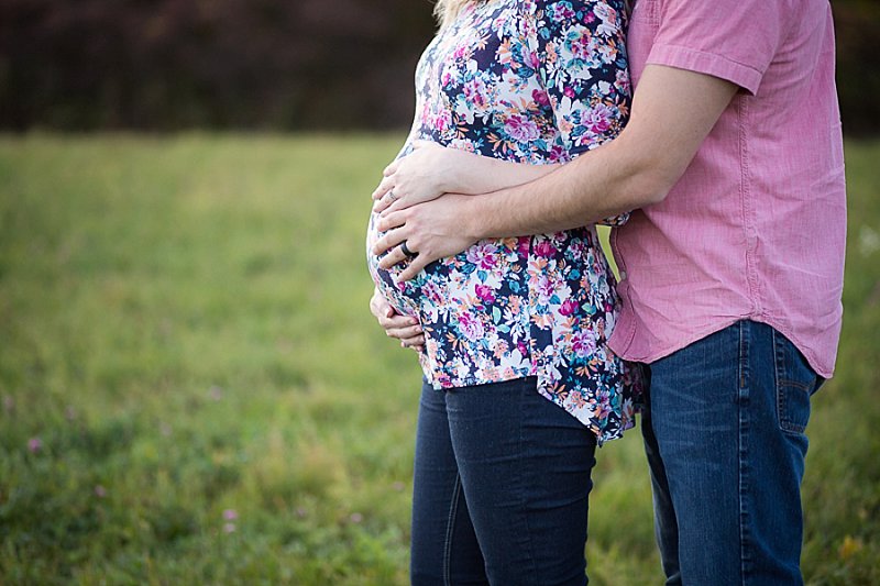 Maternity hands holding belly