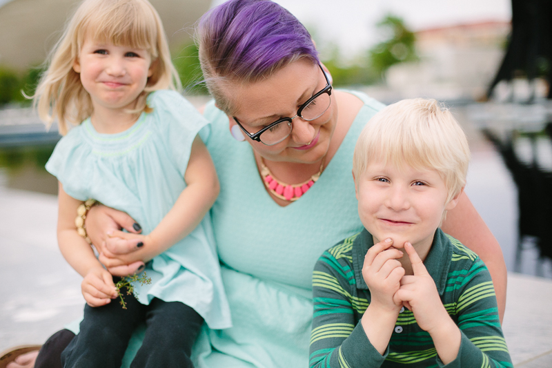 Mom looking at son holding daughter