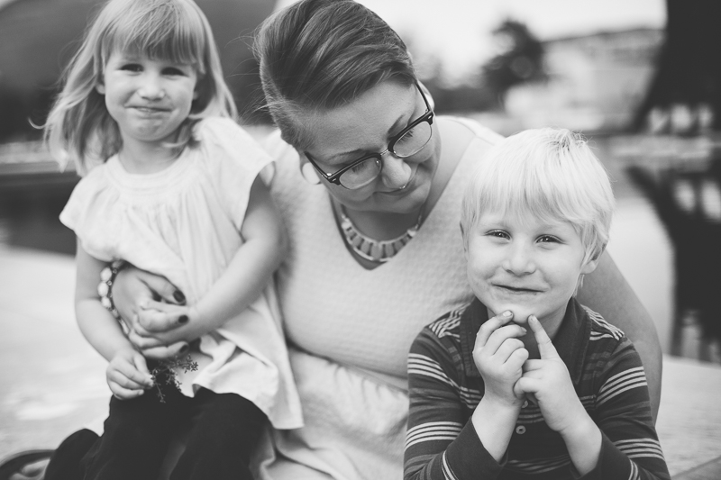 mom looking at son and holding daughter