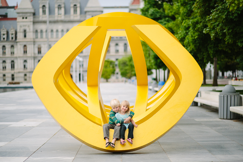 Kids sitting on sculpture Empire State Plaza