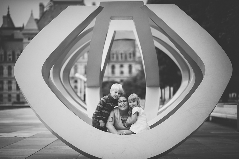 black and white portrait sitting on a sculpture