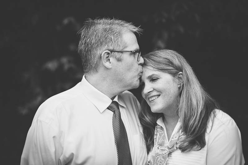 portrait of husband kissing wife forehead