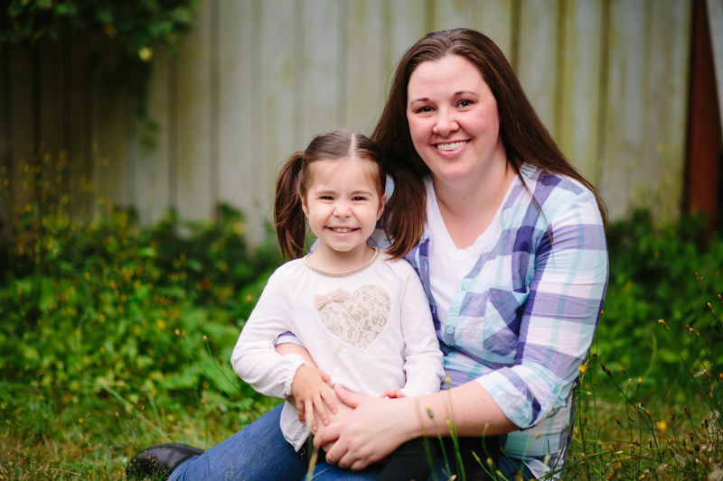 little girl sitting on her moms lap