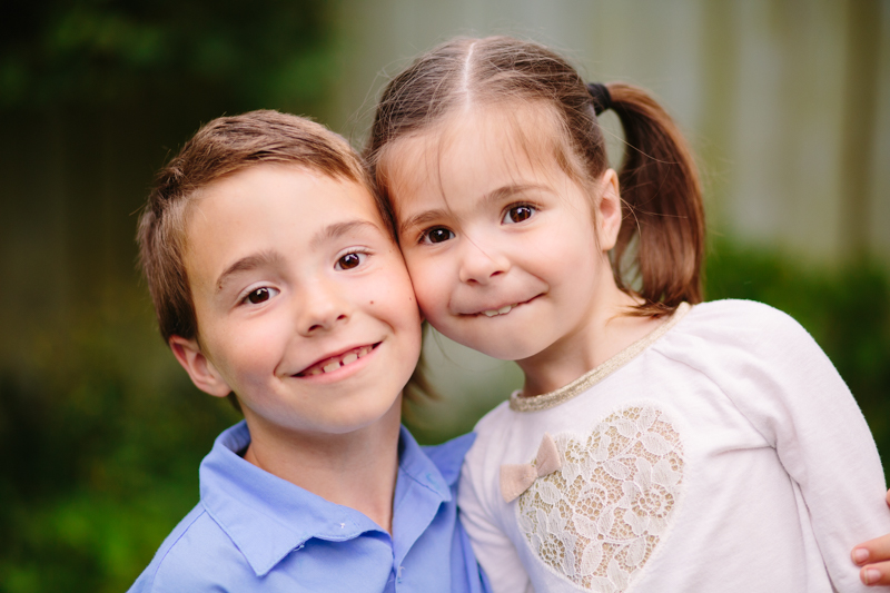 brother and sister faces close together