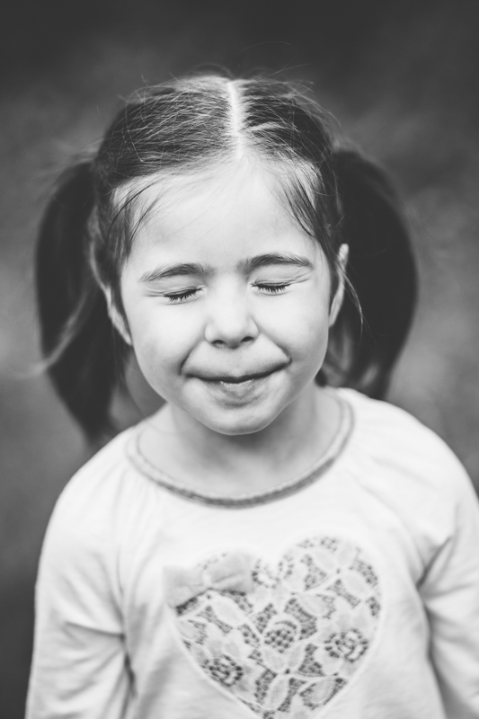 black and white picture of a young girl with eyes closed