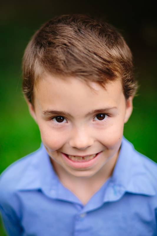 close up picture of little boy in blue shirt