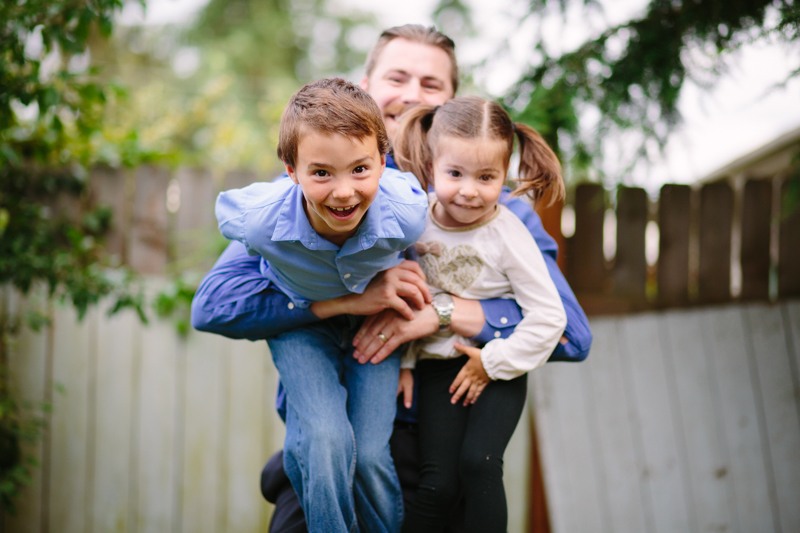 dad picking up his little boy and girl
