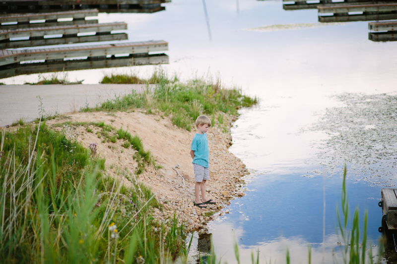 little boy looking at water in the marina
