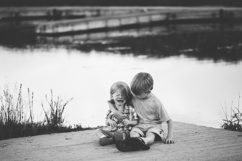 Big brother comforting sad little brother