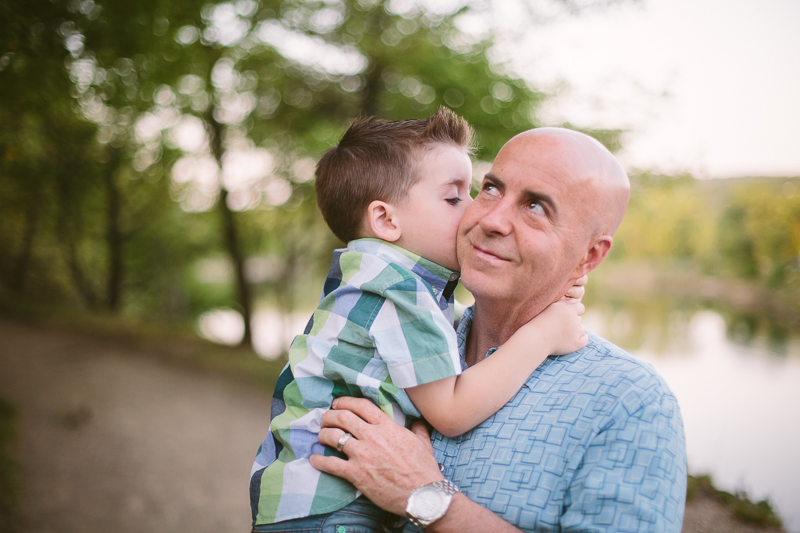 Boy child giving dad kiss on his cheek