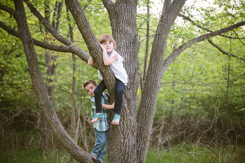 Boy and girl climbing a tree
