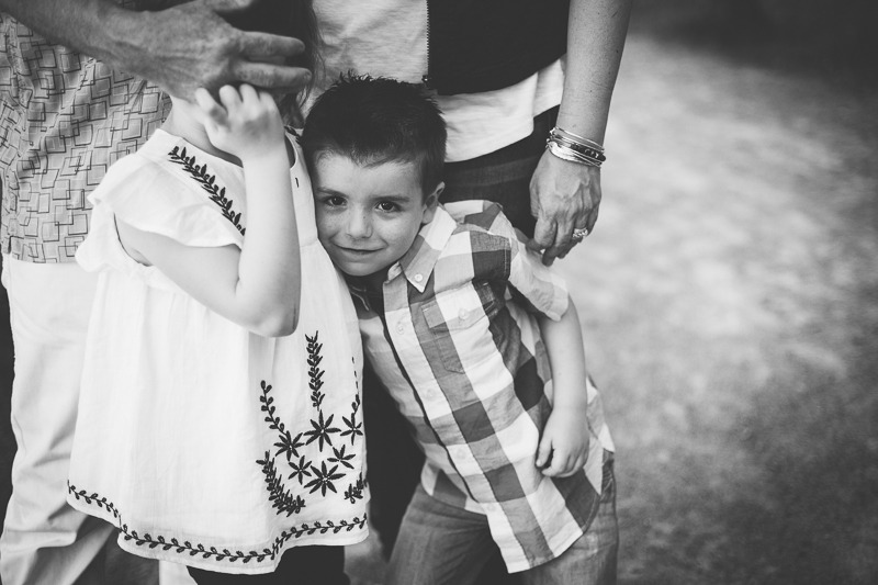 boy snuggling with sister black and white