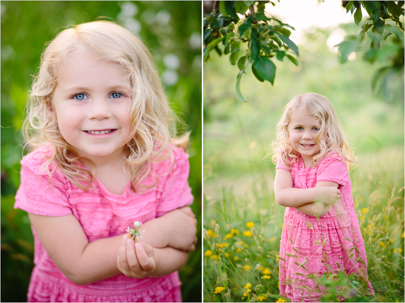 Little girl in pink dress in apple orchard