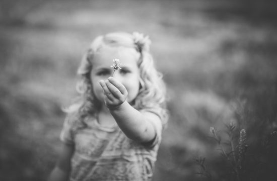 Little girl holding a flower