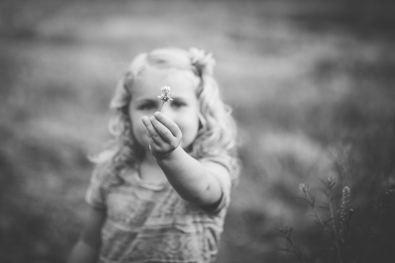 Little girl holding a flower