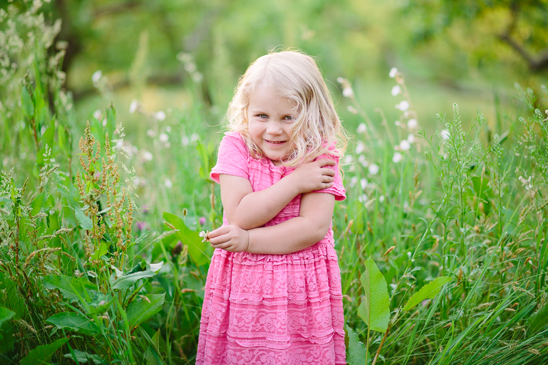 Girl giving herself a hug pink dress