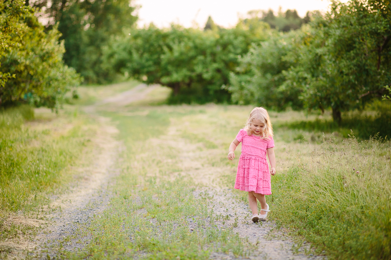 little girl walking on a dirt road 
