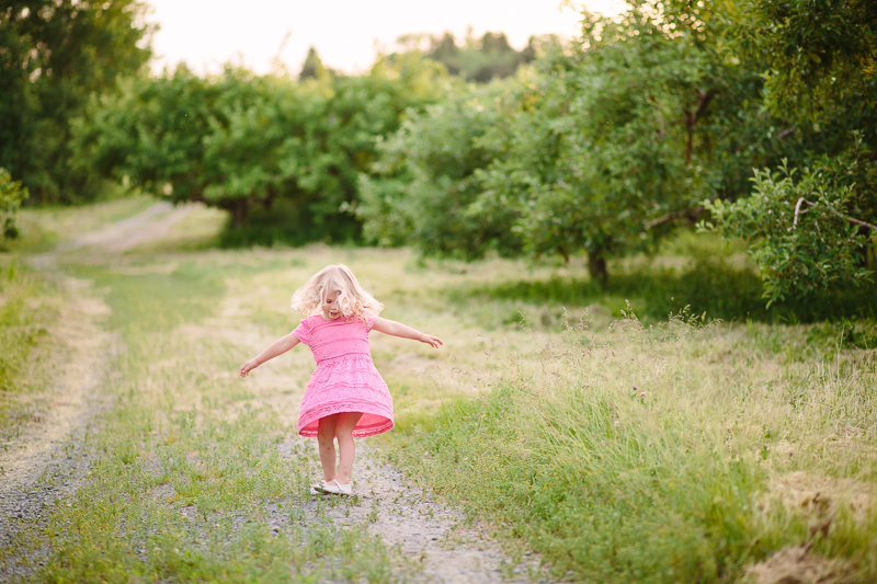 girl in a pink dress twirling at Lindsey's Orchard NY