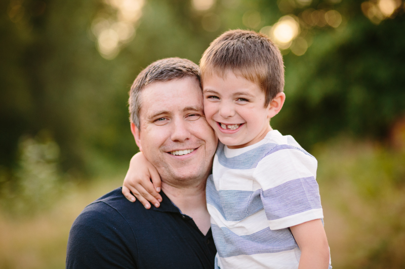 little boy hugging dad's head
