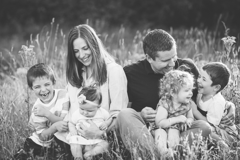 family of six snuggling and tickling each other