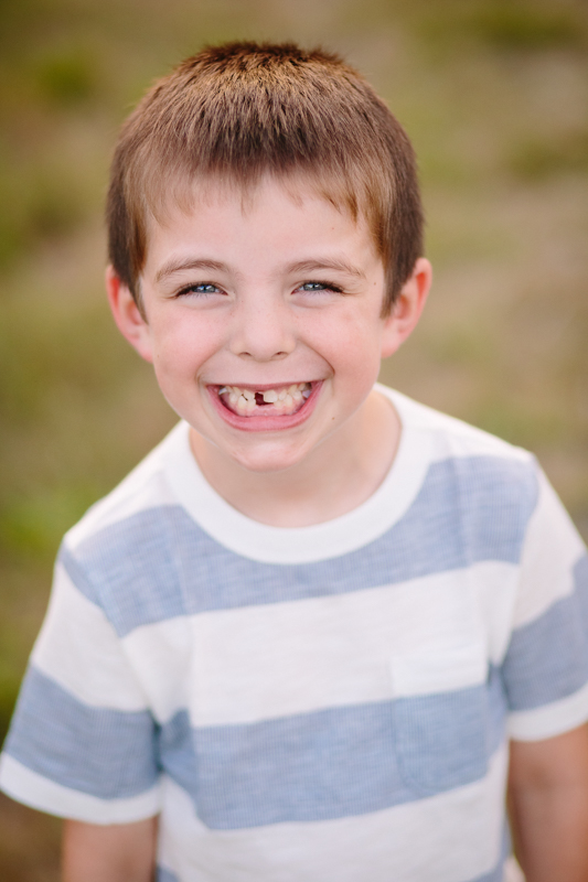 little boy smiling with a tooth missing
