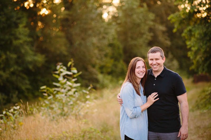 husband and wife standing close at sunset
