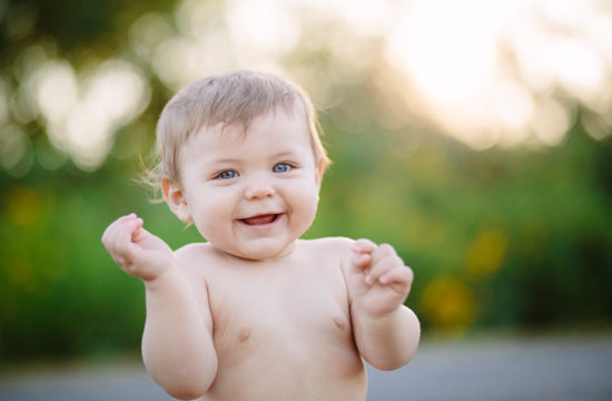 Baby boy hands up smiling