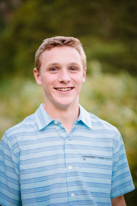 young man with blue shirt, blonde hair blue eyes