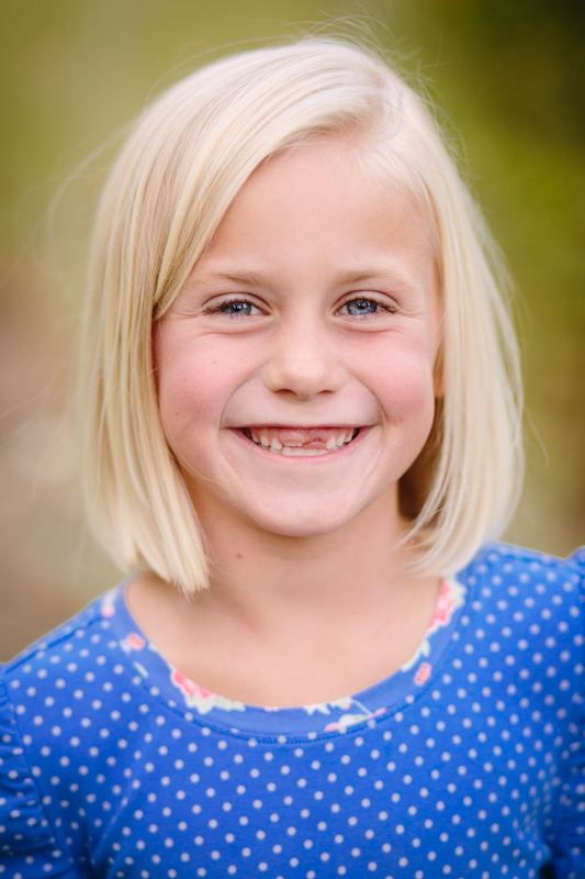 little girl with blue dress blonde hair 