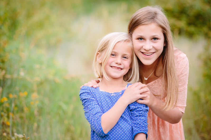 sisters hugging and holding hands