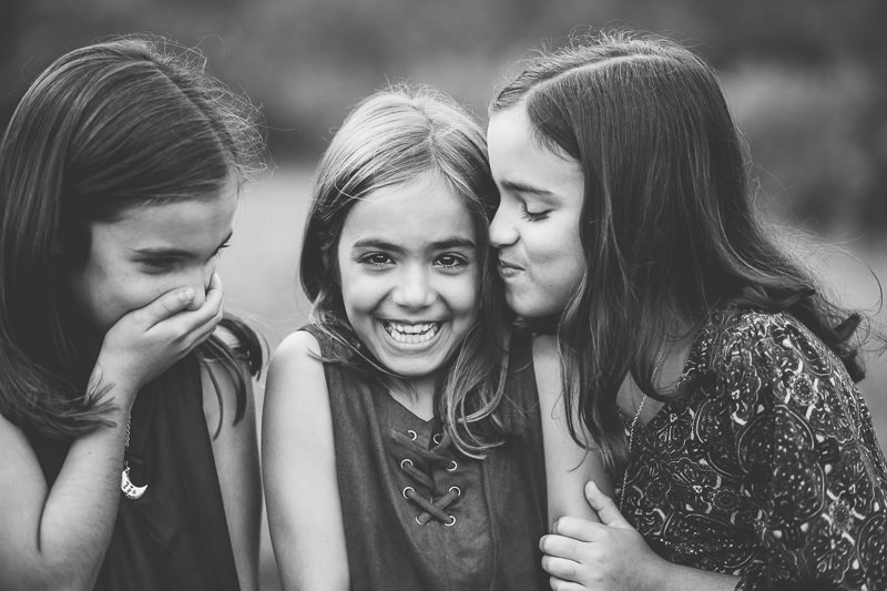 sister giving a kiss and laughing