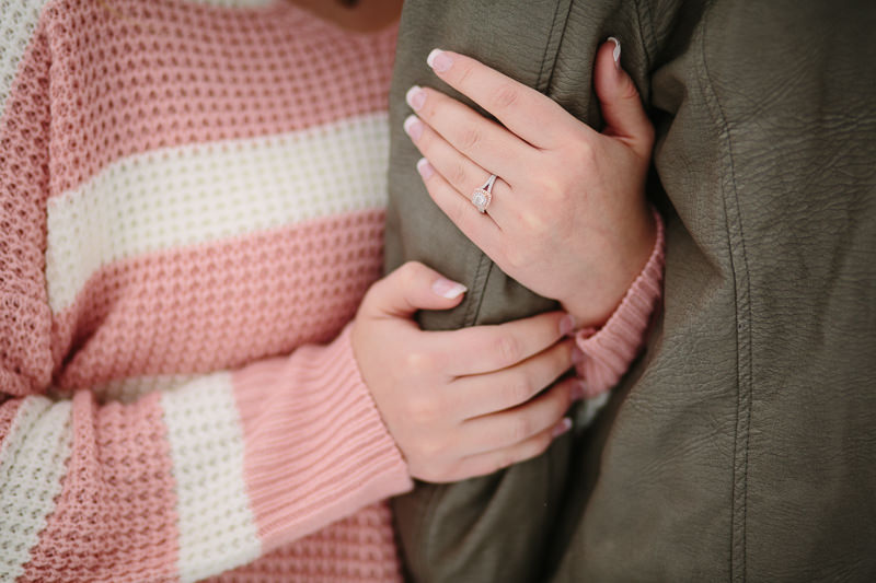 engagement ring and manicured nails holding arm