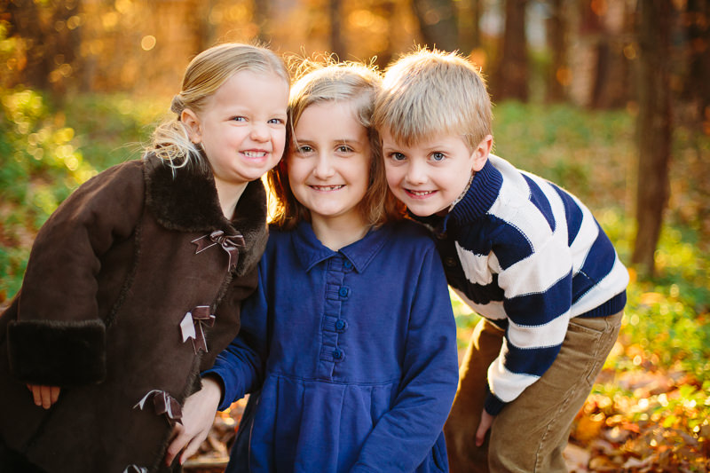 three siblings snuggled close together