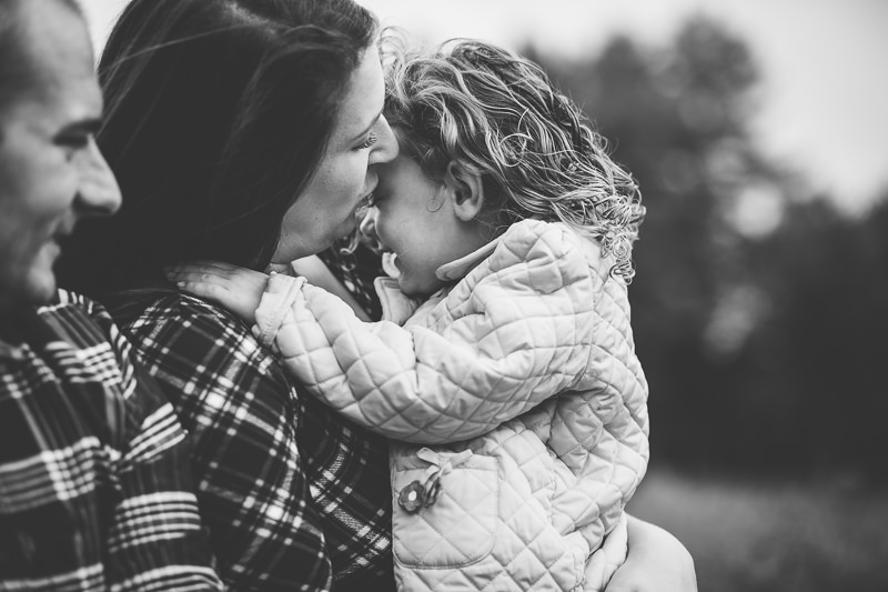 little girl snuggling close to mom