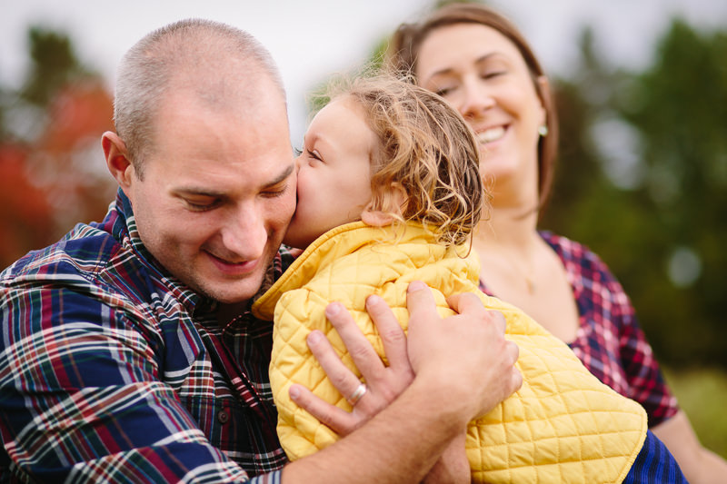 little girl kissing dads cheek