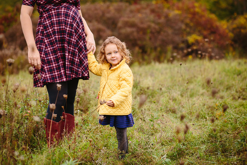 pregnant mom belly holding daughter hand 