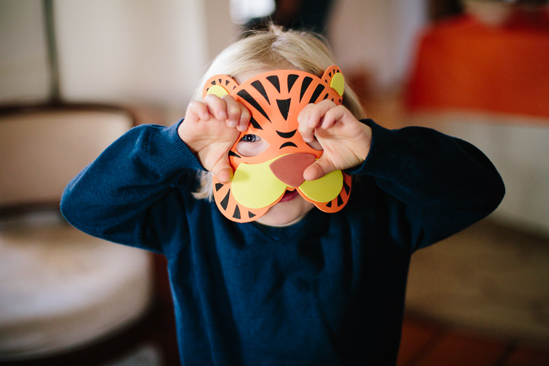little boy in tiger mask showing claws